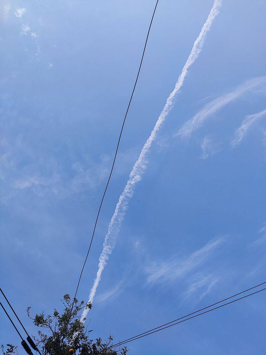 Contrails. The visible trail is condensed water vapour.