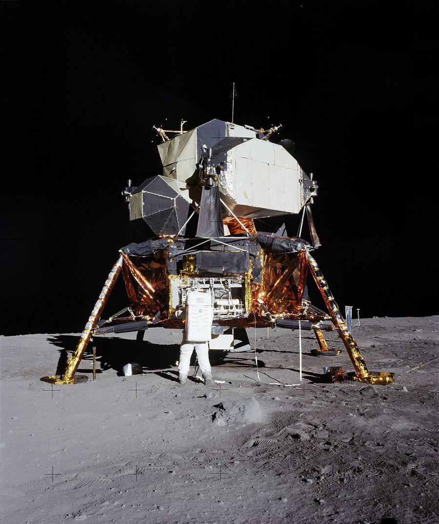 Buzz Aldrin removing the passive seismometer from a compartment in the SEQ bay of the Lunar Lander