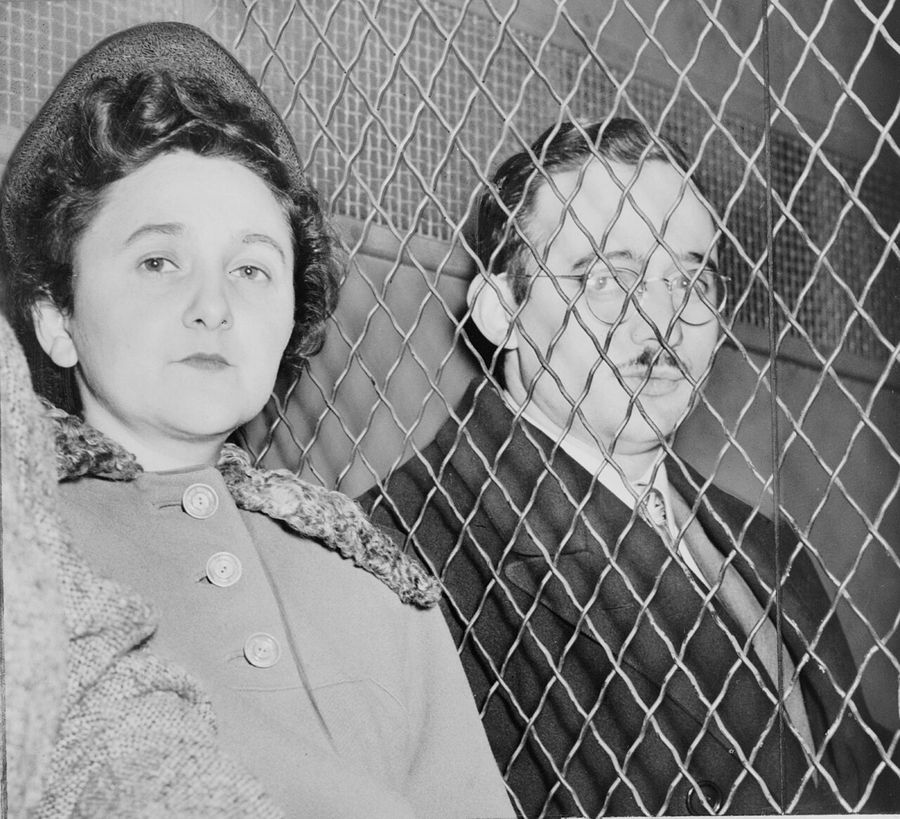 Julius and Ethel Rosenberg, separated by heavy wire screen as they leave U.S. Court House after being found guilty by jury